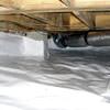 Bare floor joists in a sealed, insulated crawl space in Coquitlam.