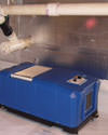 A dehumidifier being vented into a finished basement