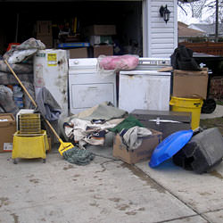 Soaked, wet personal items sitting in a driveway, including a washer and dryer in Chilliwack.