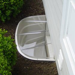 A vinyl basement window and covered window well in Cultus Lake