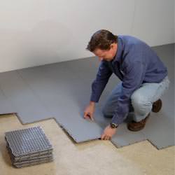 basement subfloor tiles being installed by a contractor in Deep Cove