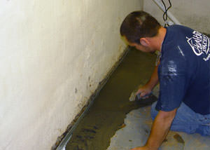 Restoring a concrete slab floor with fresh concrete after jackhammering it and installing a drain system in Deep Cove.